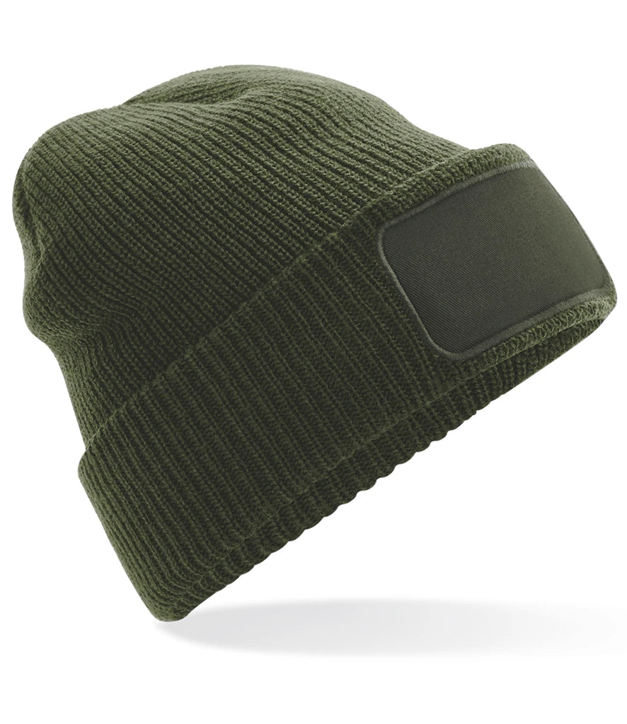 Green knit beanie with a black patch on a white background