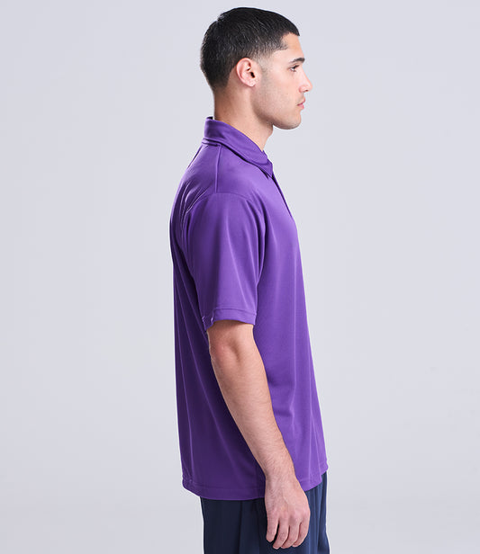 Man wearing a purple polo shirt against a light gray background