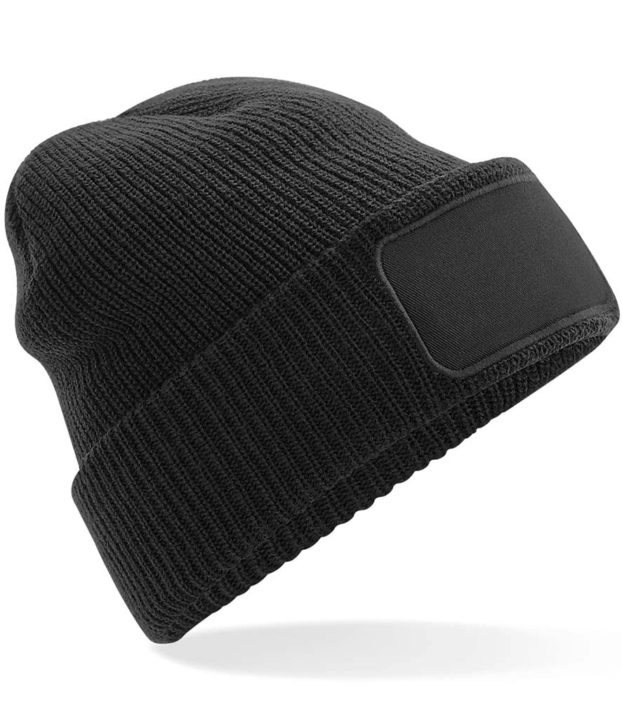 Black knit beanie with a patch on a white background
