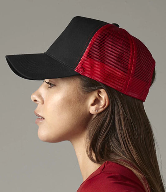 Woman wearing a black and red trucker hat on a gray background
