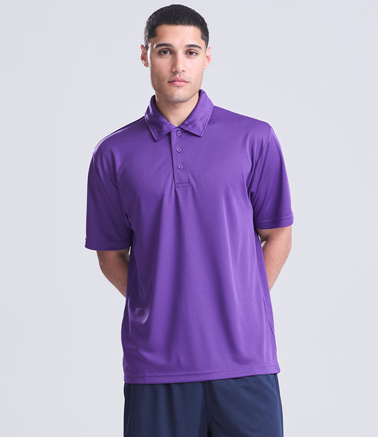 Man wearing a purple polo shirt on a light gray background