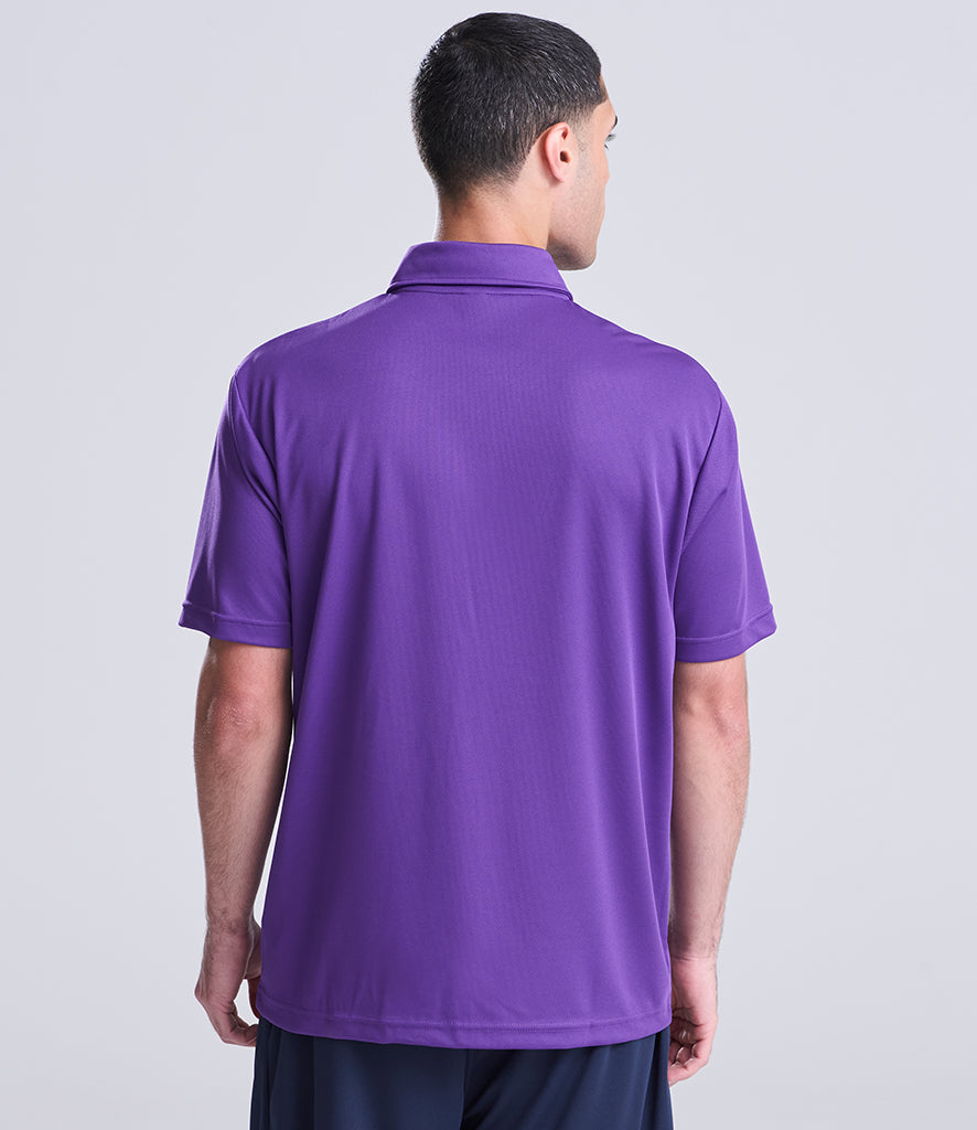 Man wearing a purple polo shirt on a light gray background
