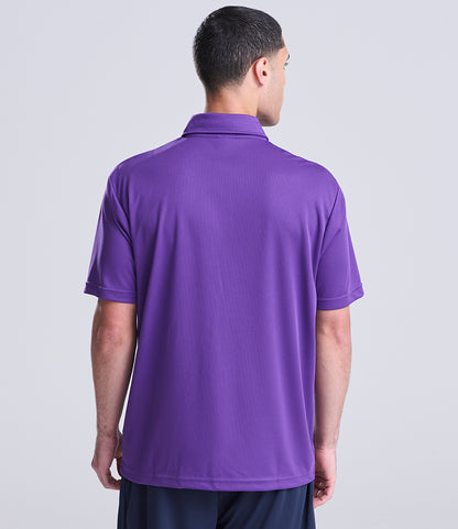 Man wearing a purple polo shirt on a light gray background