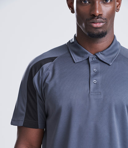 Man wearing a gray polo shirt with black accents on a white background