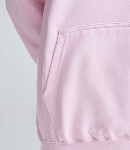 Close-up of a pink hoodie with a pocket on a light gray background
