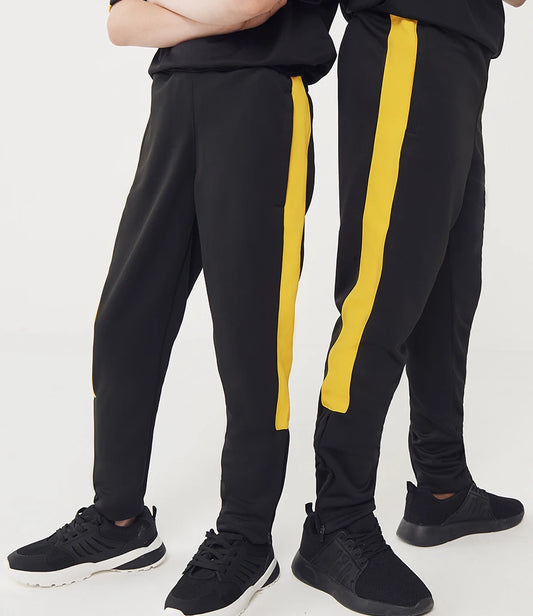 Black track pants with yellow stripes worn by a person on a white background