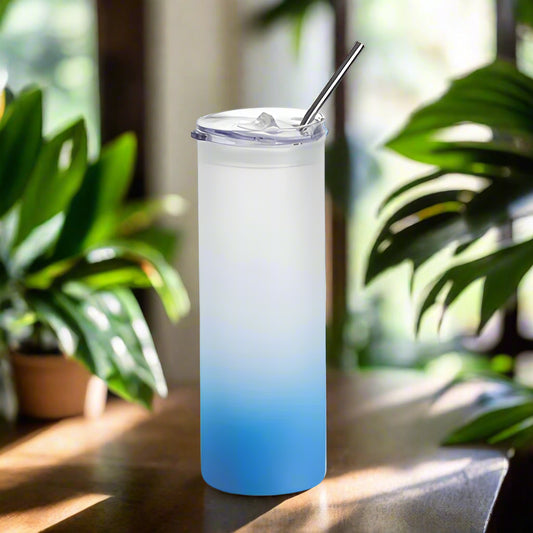 Gradient blue to clear tumbler with a straw on a white background