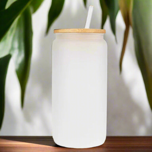 White tumbler with a wooden lid and straw on a white background